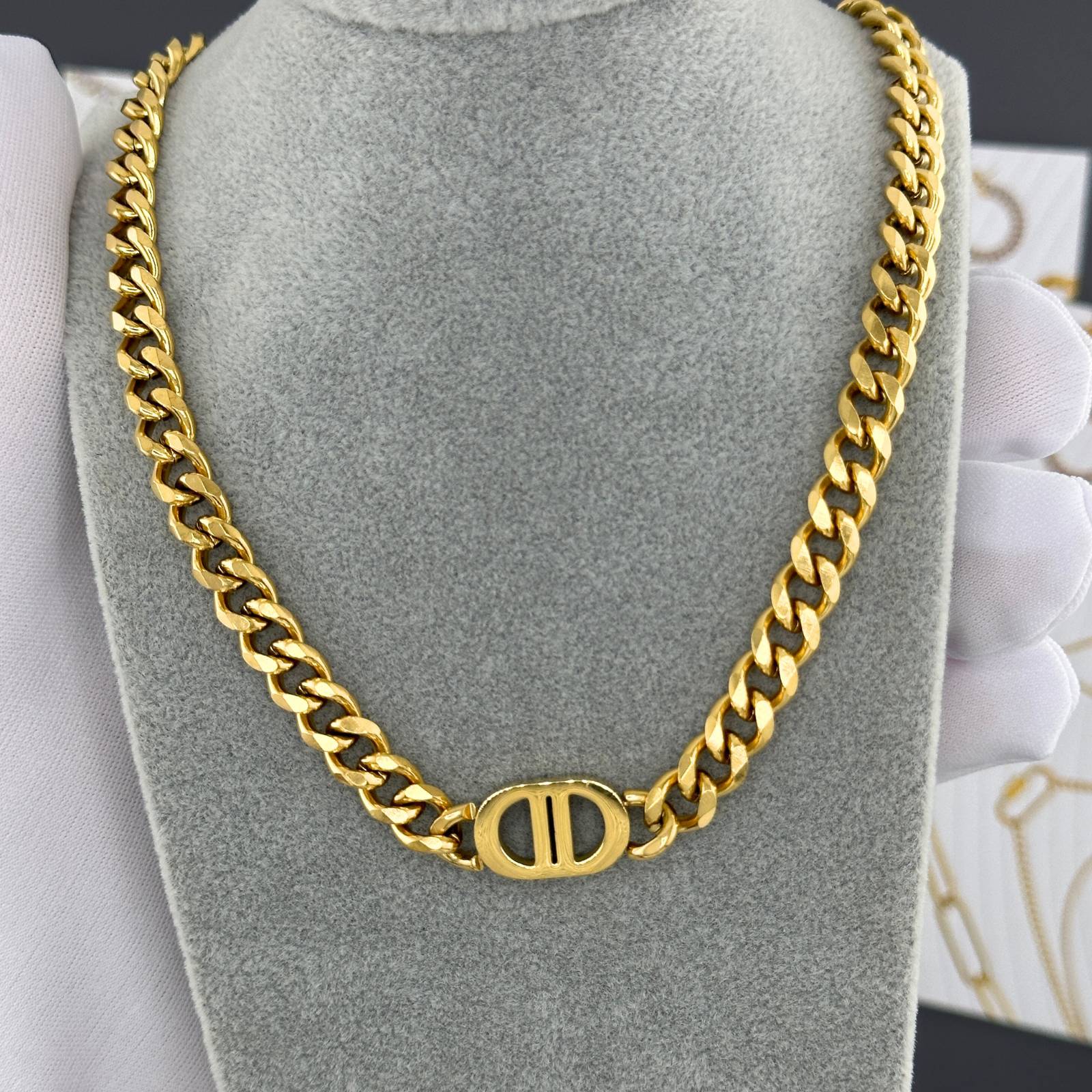 Gold-plated stainless steel signature link necklace with a modern chain design and polished centerpiece accent.