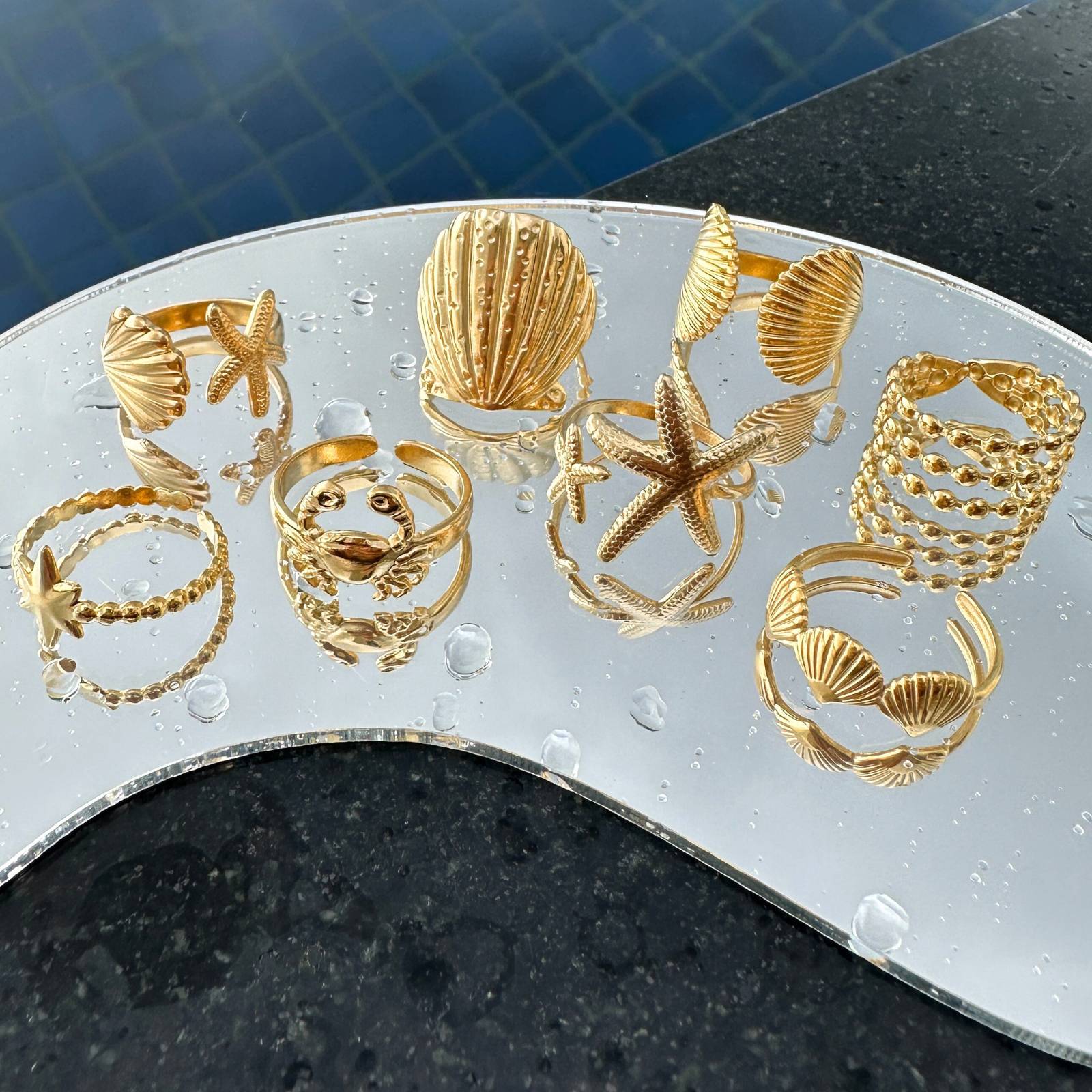 Multi-row gold beaded adjustable ring crafted from 18K gold-plated stainless steel and other rings.