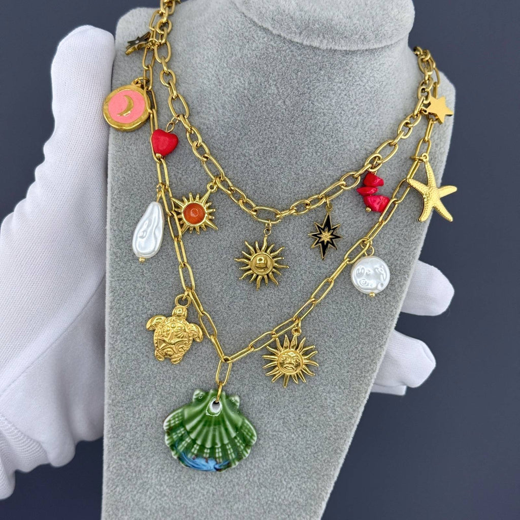 Layered Green seashell pendant necklace featuring pearl accents, starfish charm, and coastal-inspired details crafted from waterproof hypoallergenic stainless steel.