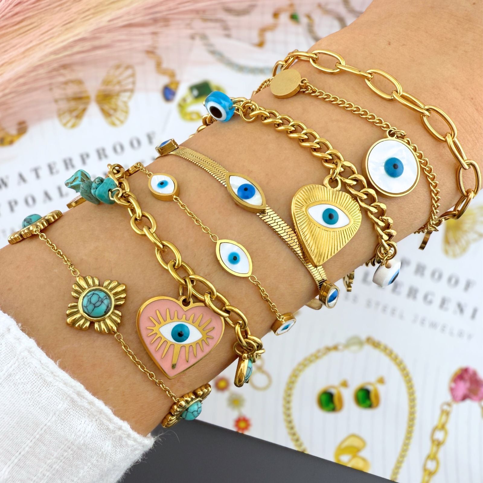 Multiple 18K gold plated stainless steel evil eye bracelet featuring blue enamel accents and an adjustable chain.