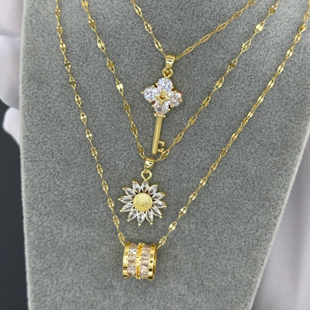 Lyered Sunflower-inspired pendant necklace with cubic zirconia stones in 18K gold-plated stainless steel.