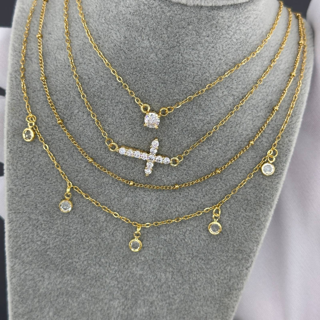 Layered gold necklace with delicate cubic zirconia charms in 18K gold-plated stainless steel.