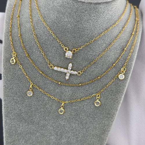 Layered gold necklace with delicate cubic zirconia charms in 18K gold-plated stainless steel.