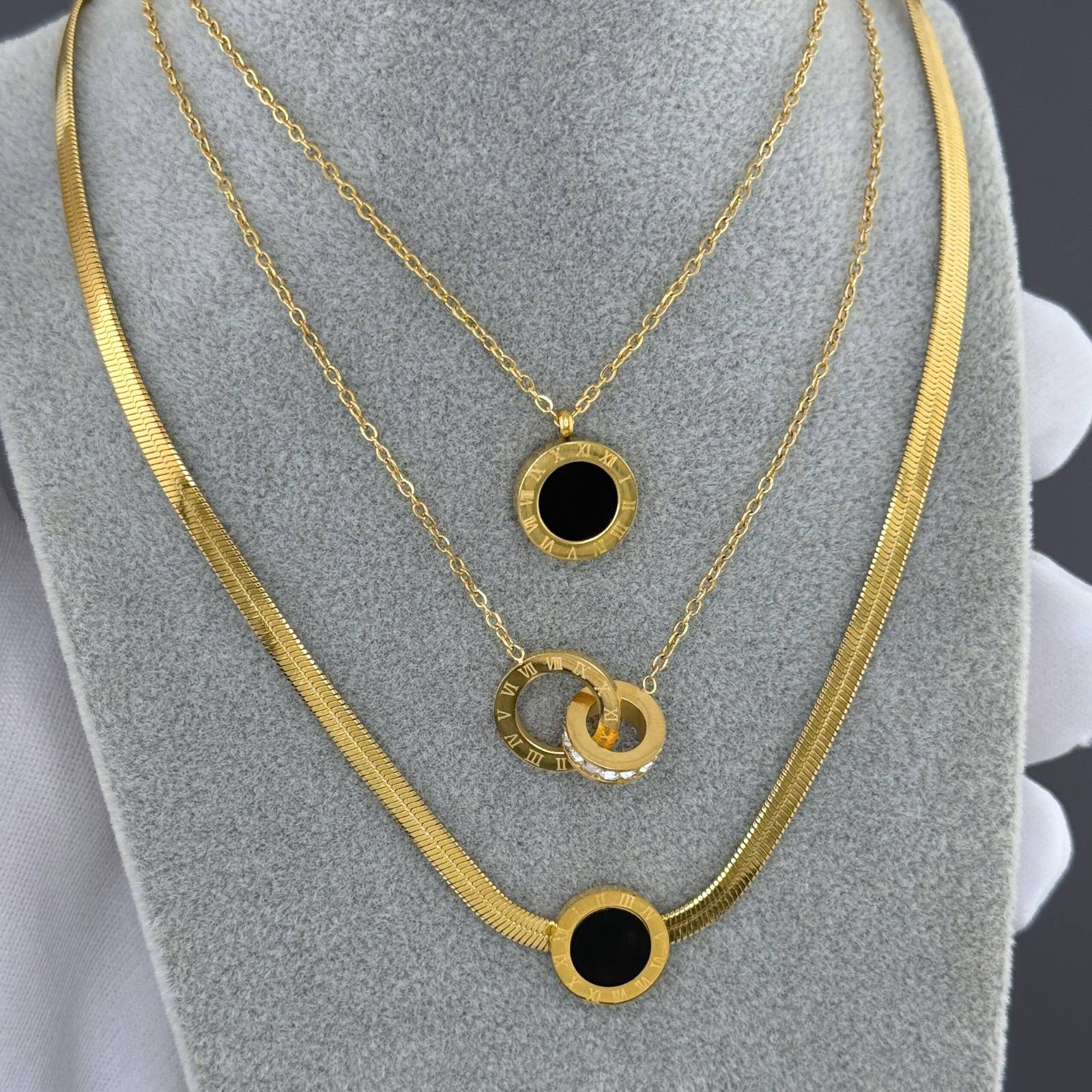 Layered Interlocking circle necklace with Roman numeral detailing and cubic zirconia accents in 18K gold-plated stainless steel.