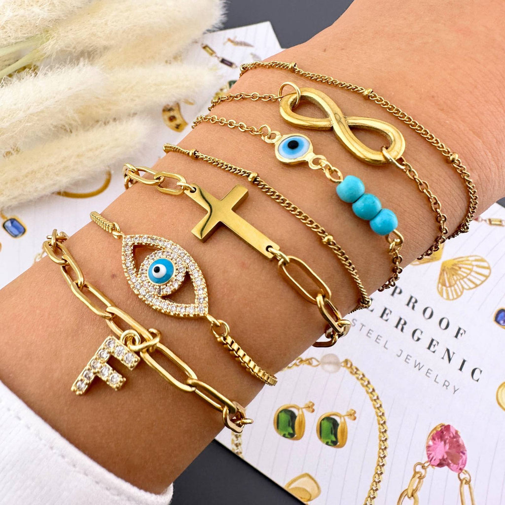 18k Gold-plated  bracelets with various designs on a wrist.