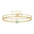 18K gold plated stainless steel layered bracelet featuring a cubic zirconia evil eye charm and adjustable chain design.