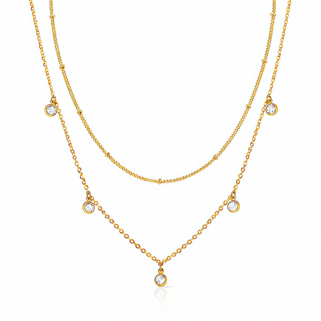 Layered gold necklace with delicate cubic zirconia charms in 18K gold-plated stainless steel.