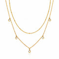 Layered gold necklace with delicate cubic zirconia charms in 18K gold-plated stainless steel.