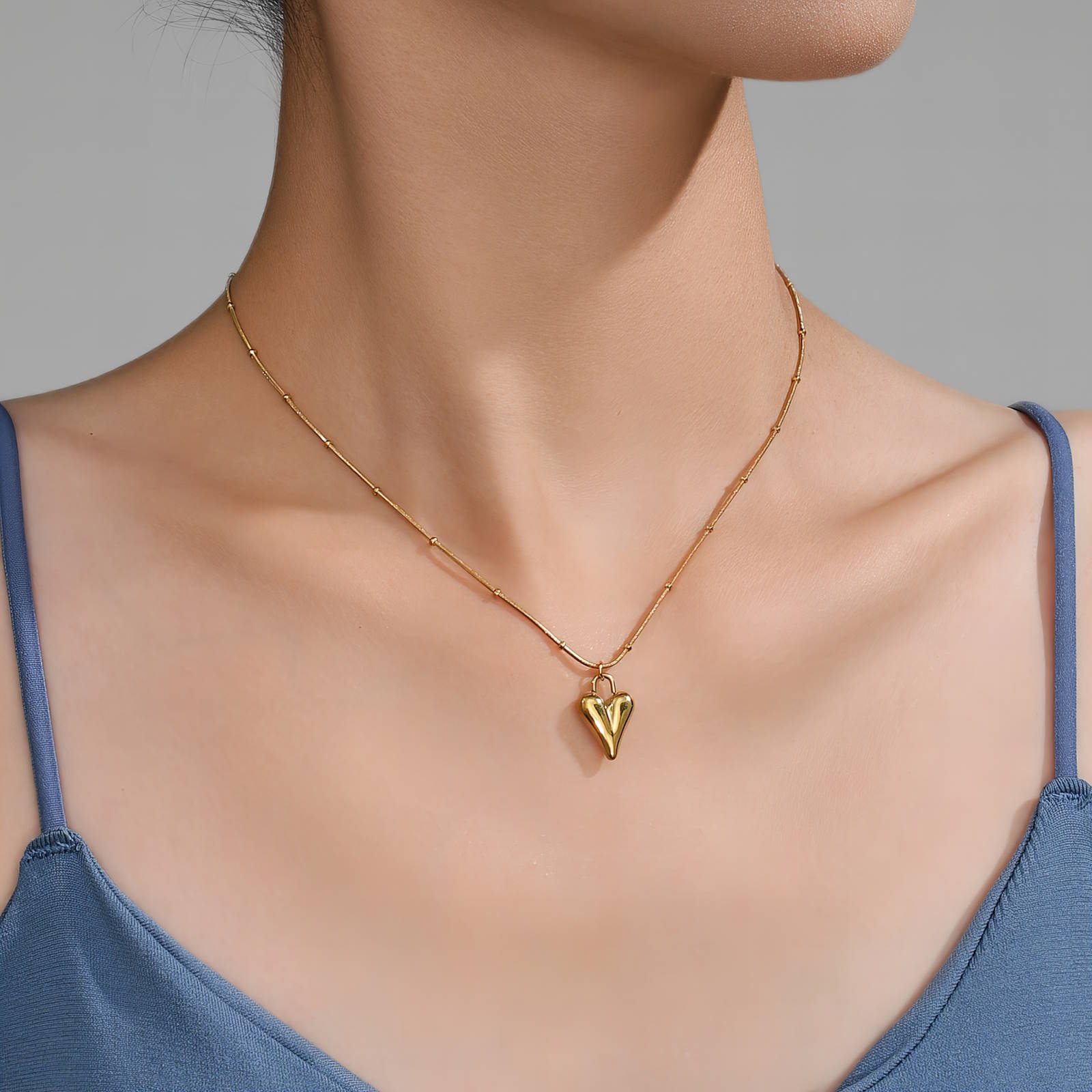 Open heart pendant necklace in 18K gold-plated stainless steel with a minimalist romantic design.