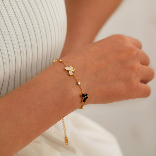 18K gold plated stainless steel butterfly charm bracelet featuring cubic zirconia accents and an adjustable chain design.