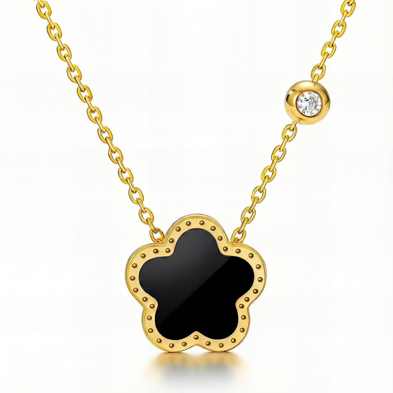 Black flower pendant necklace with cubic zirconia accent in 18K gold-plated stainless steel.