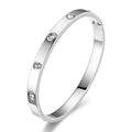 Stainless steel bangle bracelet featuring sparkling cubic zirconia stones and a sleek polished silver-tone finish.