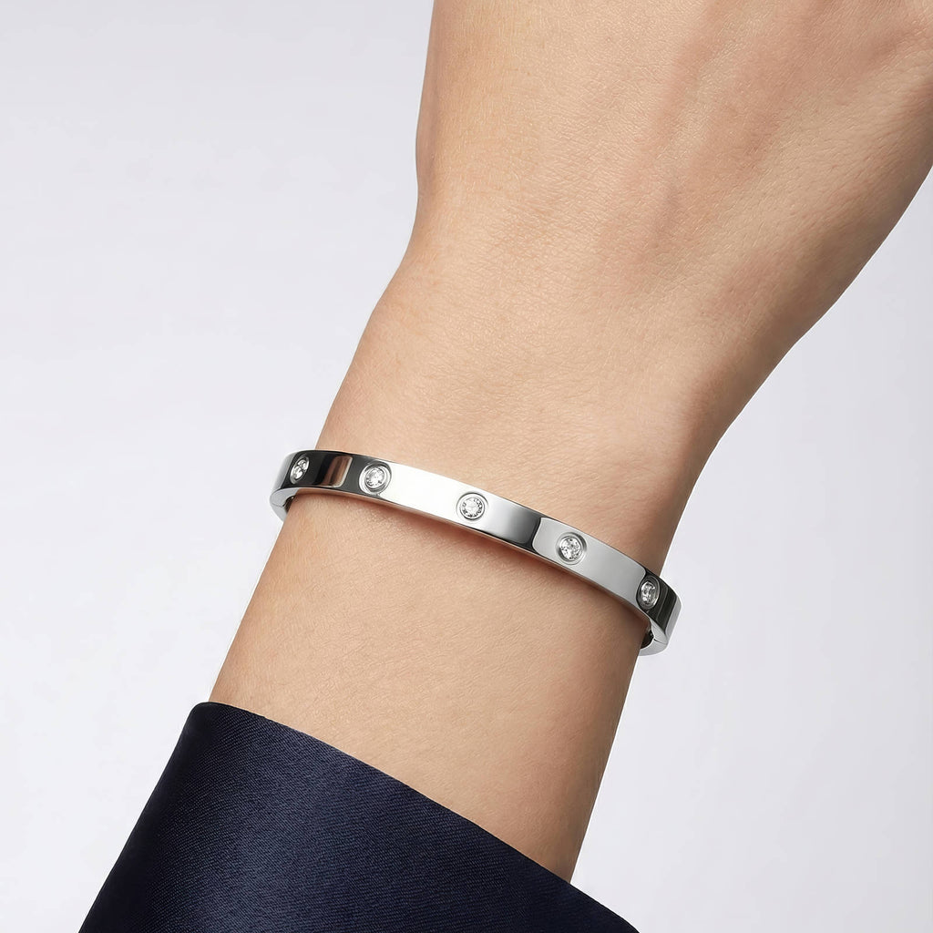 Stainless steel bangle bracelet featuring sparkling cubic zirconia stones and a sleek polished silver-tone finish.