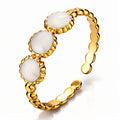 18K gold plated stainless steel adjustable ring featuring three white enamel stones on a textured gold band.