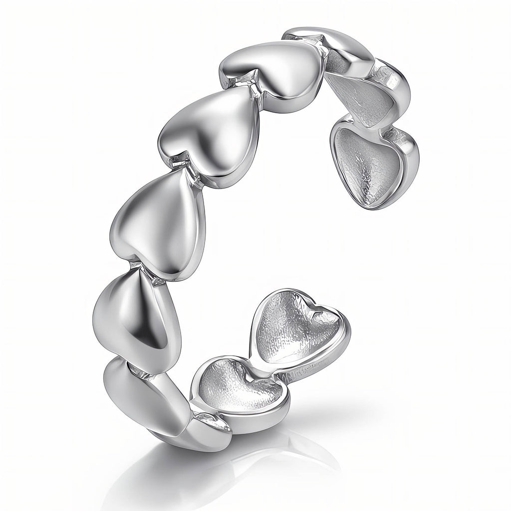Polished stainless steel adjustable ring featuring a continuous band of heart-shaped links in a modern silver finish.