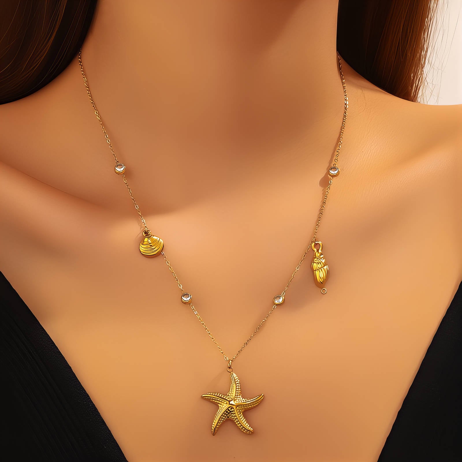 Gold starfish necklace with seashell charms and cubic zirconia accents crafted from waterproof hypoallergenic stainless steel.