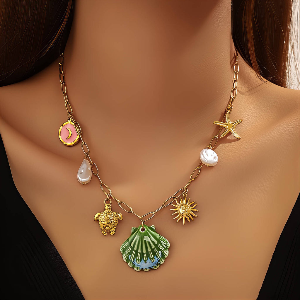 Green seashell pendant necklace featuring pearl accents, starfish charm, and coastal-inspired details crafted from waterproof hypoallergenic stainless steel.