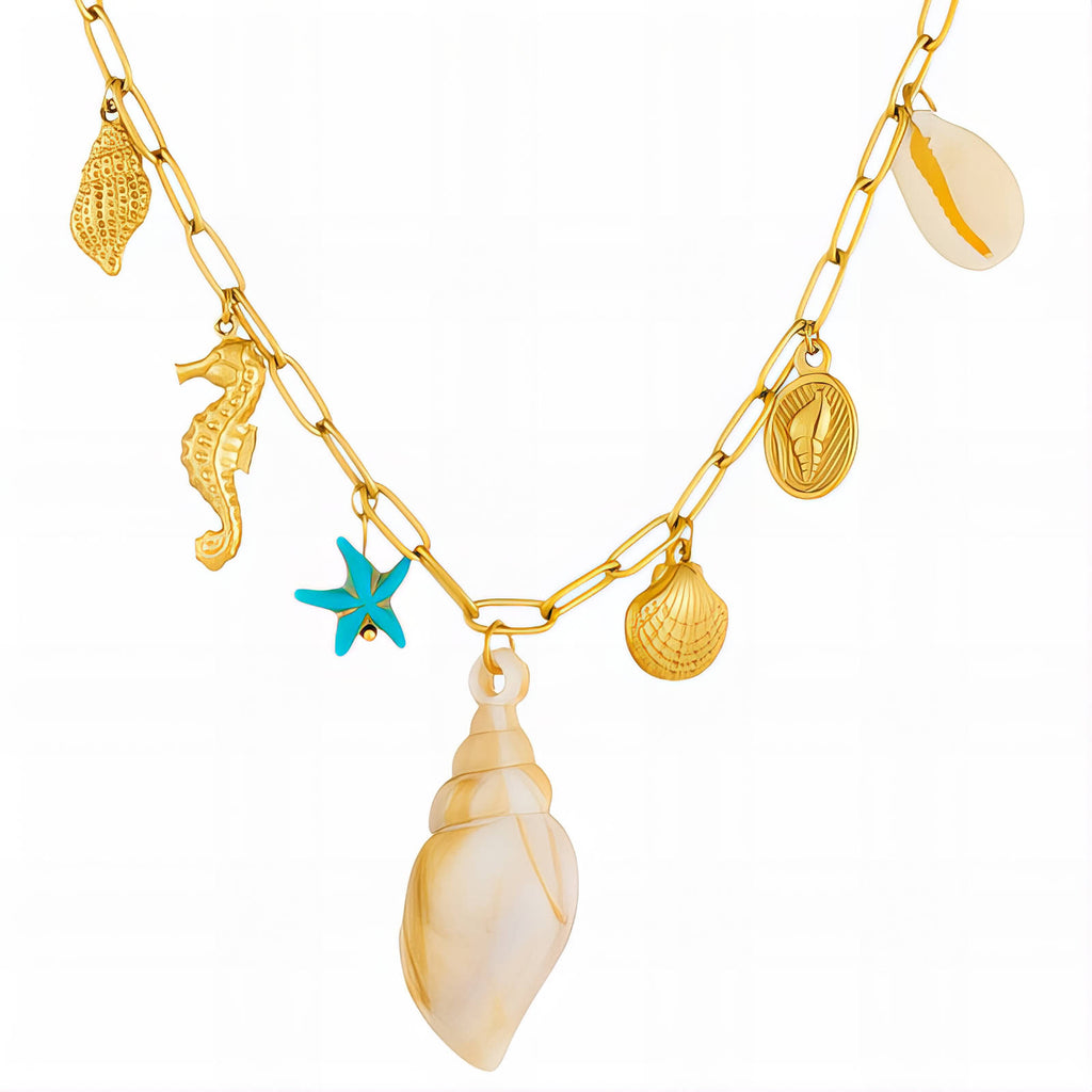 Gold ocean charm necklace featuring a seashell pendant, starfish charm, seahorse charm, and coastal-inspired details crafted from waterproof hypoallergenic stainless steel.