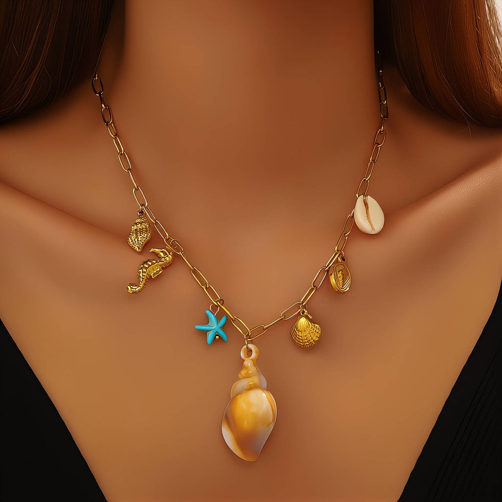 Gold ocean charm necklace featuring a seashell pendant, starfish charm, seahorse charm, and coastal-inspired details crafted from waterproof hypoallergenic stainless steel.