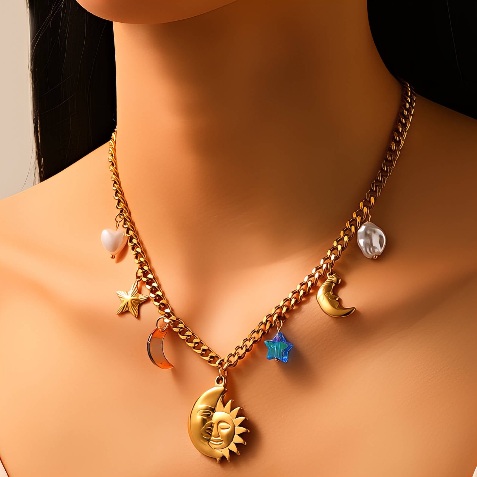 Gold celestial charm necklace featuring sun, moon, and star pendants crafted from waterproof hypoallergenic 18K gold-plated stainless steel.