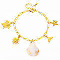 18K gold plated stainless steel ocean charm bracelet featuring seashell, starfish, sea turtle, sunburst, and whale tail charms with adjustable chain.