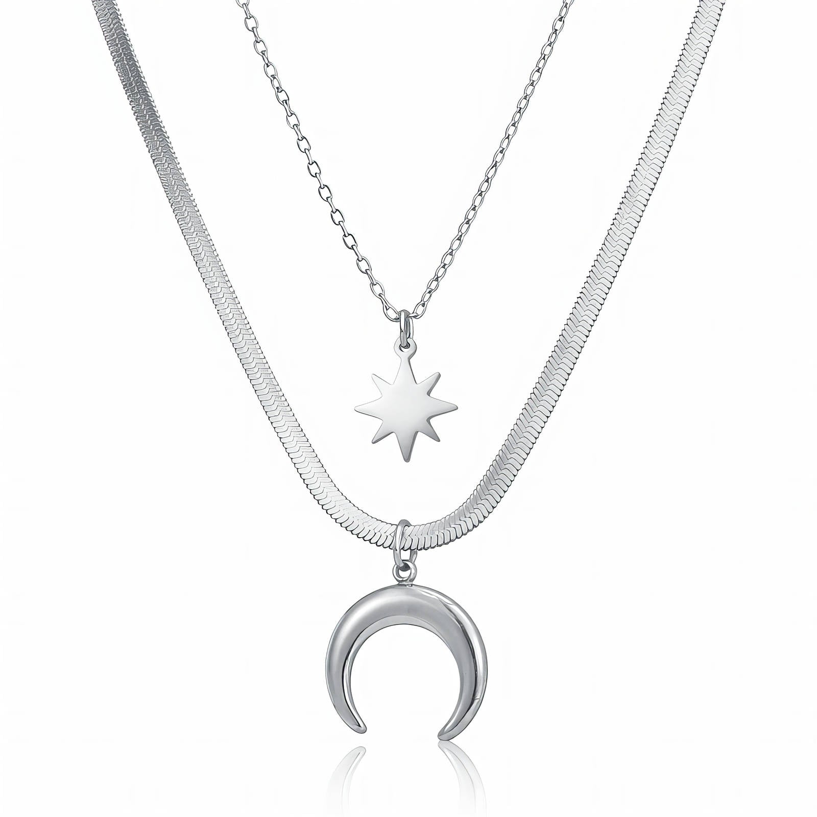 Layered silver stainless steel necklace featuring crescent moon and starburst celestial pendants with waterproof hypoallergenic design.