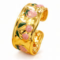 18K gold plated stainless steel cuff bracelet featuring pink strawberries, flowers, and green leaf enamel accents.