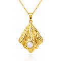 Organic gold pendant necklace featuring a pearl-inspired centerpiece crafted from waterproof hypoallergenic 18K gold-plated stainless steel.
